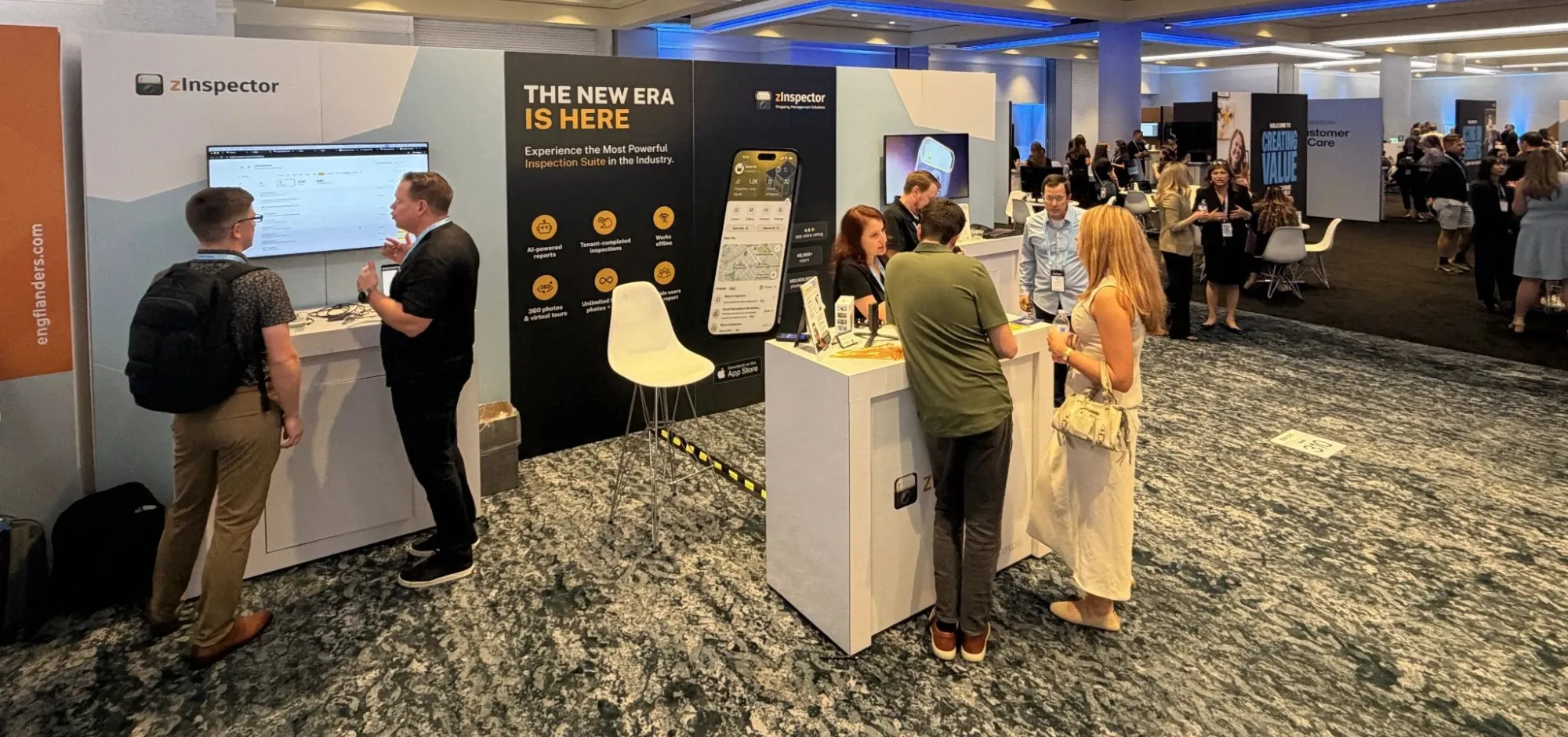 zInspector booth at NARPM with customers talking to the team